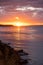 Kea, Tzia island, destination Greece. Sunset, sunrise orange through clouds background. Vertical photo