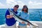 Keaton Cook right, Mate on the charter fishing vessel `Reef Runner,` helps hold a barracuda with fisherman, George Wilson.