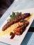 Kebab and rice with a side of grilled tomatoes spiced with herbs