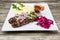 Kebab.Traditional Oriental dish, barbecue shish kebab. Lamb, onions, cabbage, mashed potatoes spicy tomato sauce on plate on a woo