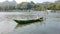 Kebumen, Central java Indonesia July 23 2023: Traditional fishing boats on the river with green trees in the background