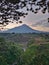 Kedung kayang waterfall and Merapi mountain view. Sunrise with forest scenery. Magelang, Indonesia