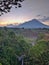 Kedung kayang waterfall and Merapi mountain view. Sunrise with forest scenery. Magelang, Indonesia