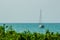 Keel boat moored at shore side, view from forest beach. Seascape