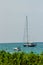 Keel boat moored at shore side, view from forest beach. Seascape