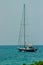 Keel boat moored at shore side, view from forest beach. Seascape