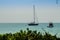 Keel boat moored at shore side, view from forest beach. Seascape