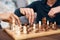 Keep boredom at bay with a game of chess. an unrecognisable couple playing a game of backgammon at home.