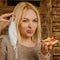 Keep calm and bon appetit! Portrait of young bold beautiful woman eating pizza without medicine respirator mask