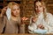 Keep calm and bon appetit! Two young bold beautiful women eating pizza without medicine respirator mask