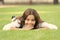 Keep calm and relax. Happy child with school look lying on green grass. Little girl smile with formal fashion look