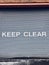 Keep clear sign on garage metal shutter door