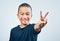 Keep it cool yall. Studio shot of a cute little boy making a peace sign against a grey background.