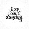 Keep on dancing - hand drawn lettering phrase isolated on the white grunge background. Fun brush ink inscription for