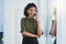 Always keep an ear out for whats coming your way. a young businesswoman making a phone call in her office.