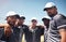 We keep it in the family, the baseball family. a group of young men huddled together at a baseball game.