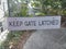 Keep gate latched sign on metal fence