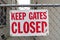 Keep Gates Closed Sign on a Chain Link Fence in an Urban Alley