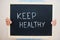 Keep healthy. Coronavirus concept. Boy hold inscription on the board