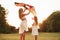 Keep holding it like that. Mother and daughter have fun with kite in the field. Beautiful nature