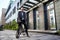 Keep moving. Full length shot of confident mature businessman looking away while standing with his bicycle near modern