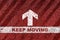 Keep moving word on starting line with arrow on red road background