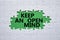 Keep an open mind symbol. White puzzle with words Keep an open mind. Beautiful green background. Business and Keep an open mind