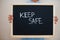 Keep safe. Coronavirus concept. Boy hold inscription on the board