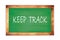 KEEP  TRACK text written on green school board