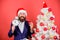 Keep track of time. Time to celebrate. Businessman join christmas celebration. Man bearded wear suit and santa hat hold