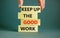 Keep up the good work symbol. Concept words Keep up the good work on wooden blocks. Businessman hand. Beautiful grey table grey