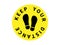 Keep your distance icon. Yellow circle with black sole prints and social spacing warning coronavirus pandemic prevention with