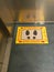 Keep your distance: multilingual sign on the floor of an italian hospital elevator. Social distancing. Covid-19 outbreak preventio