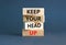 Keep your head up symbol. Concept words Keep your head up on wooden cubes. Beautiful grey table grey background. Business
