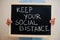 Keep your social distance. Coronavirus concept. Boy hold inscription on the board