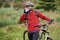 Keeping cool. An attractive male cyclist walking alongside his bike as he drinks some water.