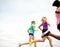 Keeping fit in fresh air surroundings. Cropped side view of a group of athletes jogging outdoors.