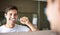 Keeping his teeth clean and healthy. Closeup of a young man brushing his teeth in the mirror.