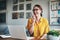 Keeping in touch with clients has never been easier. Cropped shot of an attractive young businesswoman sitting alone in