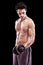 Keeping well-toned. Studio shot of a bare-chested young man lifting dumbbells isolated on black.