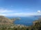 Keindahan Damai: Danau Toba yang Bersarang di Antara Bukit-bukit di Bawah Langit Biru