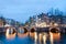 Keizersgracht inersection bridge view of Amsterdam canal and historical houses during twilight time, Netherland