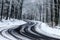 Kekesteto, Hungary - Winding winter road at the mountains of Matra near Kekesteto. Curved asphalt road with snowy trees