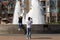 KELOWNA, BC, CANADA - AUG 30, 2020: A group of foreign tourists taking selfies in front of a fountain in Downtown Kelowna