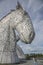 The Kelpies, horse-head sculptures, Scotland; shiny metal.