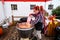 Kelsey Creek Farm Park heritage event, woman bagging kettle corn outside under a red a