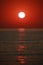 Kemer Resort, Turkey. Dawn. Sun disk on the crimson sky above the sea surface