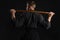 Kendo guru wearing in a traditional japanese kimono is practicing martial art with the shinai bamboo sword against a