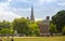 Kensington palace, queen Victoria monument in Hyde park view at sunny day with lots of people walking and resting in th, London UK