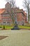 KENTShIN, POLAND. An obelisk `Memories of the died Poles 1939 - 1956` against the background of a church St. Hedgehogs